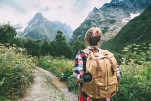 Hiker walking to mountains