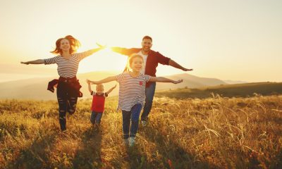 Happy family: mother, father, children son and daughter on sunset