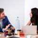 Team of coworkers collaborating on digital marketing strategy in a modern office setting.